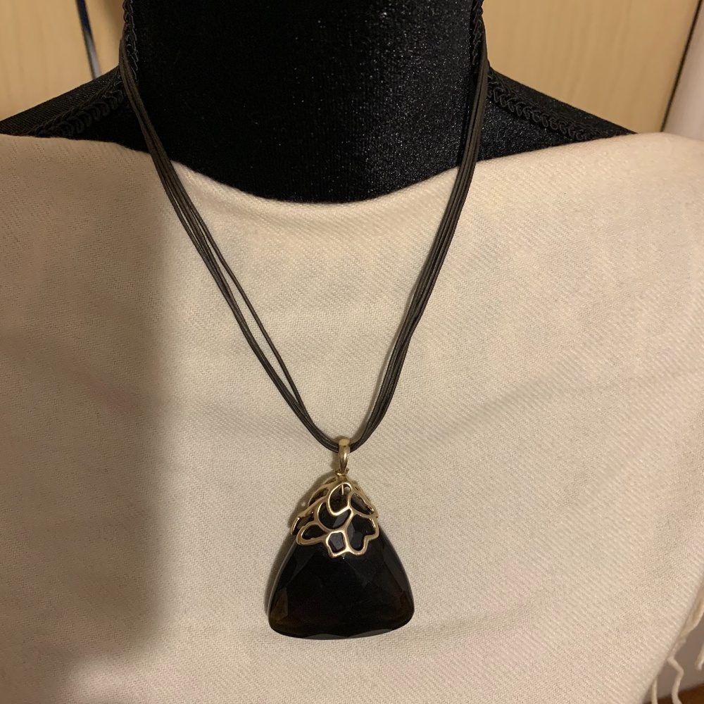 Black and gold necklace with cords and an adjustable chain